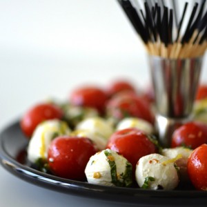 fresh mozzarella cheese board with herbs and tomatoes