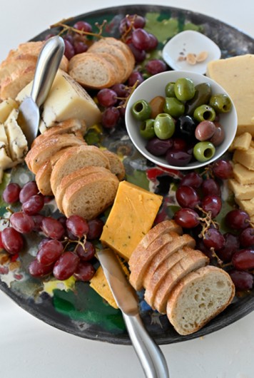 Flavored Cheese Board caramelized onion, and truffle with olives and sliced baguette